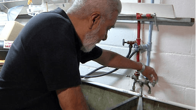 This Tuesday, May 24, 2016, image taken from video shows David G. Mata Sr. turning on the faucet in the basement of his home in Flint, Mich. State and local officials are asking Flint residents to flush the pipes in their homes every day for two weeks. Some residents like Mata are giving it a shot, but not all believe the effort will have its intended effect of helping to remove lead particles and coat the pipes.
