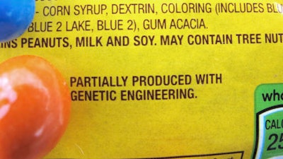 In this April 8, 2016 file photo, a new disclosure statement is displayed on a package of Peanut M&M's candy in Montpelier, Vt., saying they are 'Partially produced with genetic engineering.' Genetically manipulated food remains generally safe for humans and the environment, a high-powered science advisory board declared in a report Tuesday, May 17, 2016.