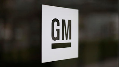 This Friday, May 16, 2014, file photo, shows the General Motors logo at the company's world headquarters in Detroit. General Motors Co. is telling dealers not to sell about 60,000 SUVs in the U.S. because the gas mileage listed on the window stickers was inadvertently overstated. The problem affects all 2016 Chevrolet Traverse, GMC Acadia and Buick Enclave models, including ones that have already been sold. The Detroit company says it will contact owners to address the problem, but it would not say if they will be compensated for the lower-than-advertised gas mileage.