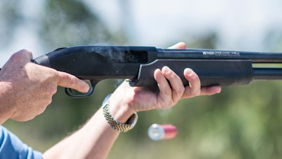In this photo taken April 7, 2016, Jonathan Mossberg, whose iGun Technology Corp. is working to develop a 'smart gun,' demonstrates the firearm, in Daytona Beach, Fla. Mossberg is among a group of pioneers looking to build a safer gun. But unlike many others, he was in the gun business when he started down that path. Mossberg has been working to develop and someday bring to market a firearm that can't be fired by the wrong person, but works without fail in the hands of its owner in a life-or-death situation.