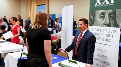 In this Wednesday, March 30, 2016, photo, recruiters speak to attendees at a job fair in Pittsburgh. On Friday, May 6, 2016, the U.S. government issues the April jobs report.