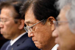 Mitsubishi Motors Corp. Chairman Osamu Masuko, center, listens to a reporter's question with President Tetsuro Aikawa, left, and Vice President Ryugo Nakao during a press conference in Tokyo, Wednesday, May 18, 2016. Aikawa said Wednesday that he will step down to take responsibility for the mileage cheating scandal unfolding at the Japanese automaker.