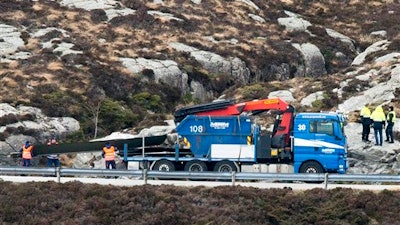 Helicopter rotor blades are loaded onto a truck following the Friday April 29 helicopter crash on the coast of Norway near Bergen, Sunday May 1, 2016. Emergency crews salvaged the wrecked fuselage of the Airbus helicopter from the sea Saturday along with the flight recorders, and retrieved the rotor blades following the crash which killed the 13 people on board.