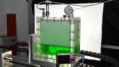 A Hiroshima University researcher traveled to the GFZ German Research Centre for Geosciences to collaborate on a project examining the connection between earthquakes and volcanic eruptions. A sealed box of a syrupy liquid (dyed green) with a tall layer of foamy bubbles on top is connected to sensors and recording equipment.