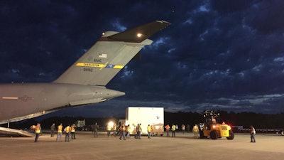 The OSIRIS-REx spacecraft is unloaded from a US Air Force C-17 cargo plane at NASA's Kennedy Space Center Shuttle Landing Facility.