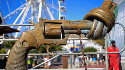 In this Tuesday, Feb. 26, 2013 file photo, a sculpture by Carl Fredrik Reutersward, titled 'knotted gun' which is a symbol designed to protest against global violence and senseless killings, is displayed in Cape Town, South Africa.