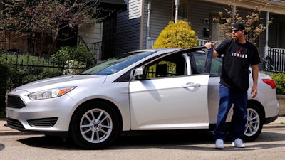 In this Tuesday, April 26, 2016, photo, Louis Cervi gets out of his leased Ford Focus after parking near his Pittsburgh home. Cervi had been looking to buy a small car for basic transportation, with a reasonable monthly payment. With many Americans rushing to buy trucks and SUVs, there are good deals to be had on cars, especially smaller models.