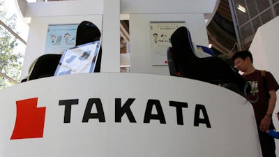 In this May 4, 2016 file photo, visitors look at child seats, manufactured and displayed by Takata Corp. at an automaker's showroom in Tokyo. Money-losing Japanese air bag maker Takata Corp. hired financial advisory and asset management firm Lazard Thursday, May 26 to help tackle financial problems and massive recalls.