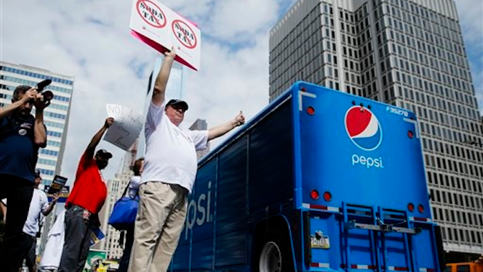 In this June 8, 2016 file photo, opponents of a proposed sugary drink tax demonstrate outside City Hall in Philadelphia. Philadelphia is set to become the first major American city with a soda tax despite a multimillion-dollar campaign by the beverage industry to block it. The City Council is expected to give final approval Thursday, June 16, 2016, to a 1.5 cent-per-ounce tax on sugary and diet beverages.