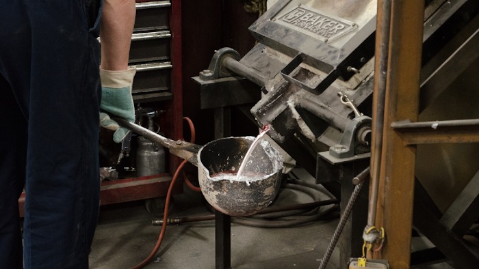 Alloyed metals being poured from a furnace into a ladle, to be used to fill molds.