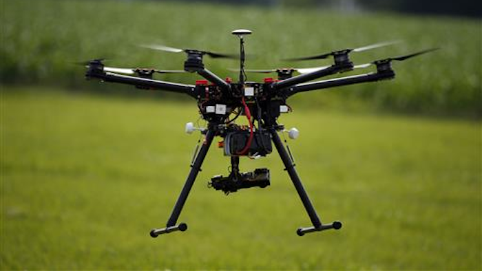A hexacopter drone is flown during a drone demonstration at a farm and winery on potential use for board members of the National Corn Growers, Thursday, June 11, 2015 in Cordova, Md. Routine commercial use of small drones got a green light from the Obama administration June 21, 2016, after years of struggling to write regulations that would both protect public safety and unleash the economic potential and societal benefits of the new technology.