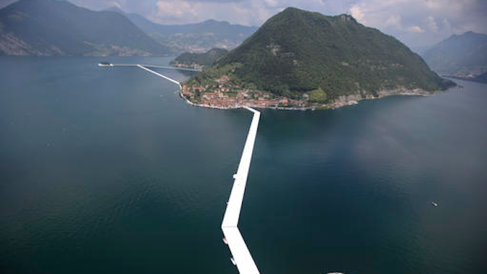 An aerial view of the in progress installation 'The Floating Piers' by Bulgarian-born artist Christo Vladimirov Yavachev known as Christo, on the Lake Iseo, northern Italy, Tuesday, June 7, 2016. Some 200,000 floating cubes create a 3-kilometers runway to be clad in bright yellow fabric and connecting the town of Sulzano to the small island of Monte Isola on the Iseo Lake for a 16-day outdoor installation opening on June 18 through July 3.