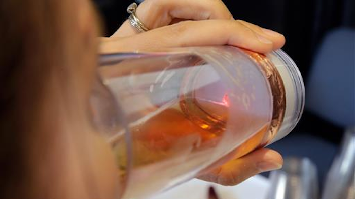 In this Wednesday, June 22, 2016, photo, the Global Ionics Beverage Power drinking device is demonstrated during a preview of products at CE Week in New York. The human body, combined with the voltage booster circuit and a single AAA battery inside the waterproof case, generates a small, safe electric current to enhance the beverage.
