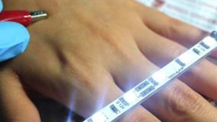 Highly conductive ultrathin film on skin between clips.