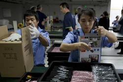 In this Tuesday, Nov. 10, 2015, photo, workers at Alco Electronics pack video display devices at the factory in Houjie Town, Dongguan City, in the Guangdong province of China. A look inside the factory shows what it takes to succeed as a maker of gadgets for the rest of the world: Human precision in tiny tasks, increasingly automated manufacturing, but also flexible thinking and perks to keep the best employees.