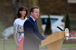 Britain's Prime Minister David Cameron speaks outside 10 Downing Street, London as his wife Samantha looks on Friday, June 24, 2016. Cameron says he will resign by the time of party conference in the fall after Britain voted to leave the European Union after a bitterly divisive referendum campaign, according to tallies of official results Friday.