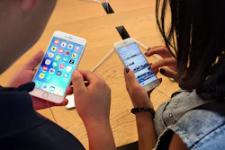 Customers try out Apple iPhone 6S models on display at an Apple Store in Beijing. A Chinese regulator has ordered Apple to stop selling two versions of its iPhone 6 in the city of Beijing after finding it looks too much like a competitor.
