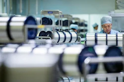 A staff member works in the workshop of an optical fiber and cable manufacturing company in Wuhan in central China's Hubei province. China's factory activity was feeble last month, according to two surveys released Wednesday, June 1, 2016, indicating that official efforts to reverse a downturn in the world's second-biggest economy are struggling.