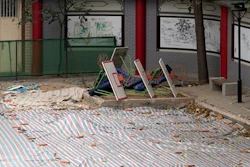 A tarp covers the ground after a running track suspected to be made from toxic material was removed from the Beijing No. 2 Experimental School near in Beijing, China, Thursday, June 23, 2016. Schools across China have been ordered to remove running tracks made from toxic materials that have been blamed for sickening students, in the latest in a long line of product scandals blamed on corruption and weak oversight.