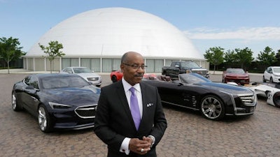 Ed Welburn, head of global design for General Motors, stands next to company concepts and production vehicles on the grounds of the company's Technical Center in Warren, Mich.