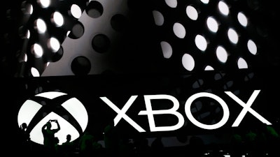 Members of the media attend a briefing at the Electronic Entertainment Expo in Los Angeles on Monday, June 13, 2016. Microsoft unveiled a new, slimmer version of the video game console coming later this year and a more powerful one that's due in 2017.