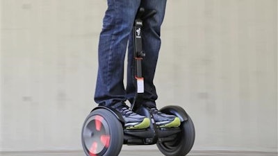 In this May 27, 2016, photo, company representative Zach Servideo demonstrates Segway's new self-balancing scooter, the MiniPro, in downtown Los Angeles. The MiniPro is going on sale on Amazon, Wednesday, June 1, 2016. Hoverboards are attempting a comeback in the U.S., months after videos showing them bursting into flame went viral.