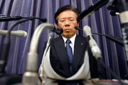 In this file photo, Mitsubishi Motors Corp. President Tetsuro Aikawa listens to a reporter's question during a press conference in Tokyo.