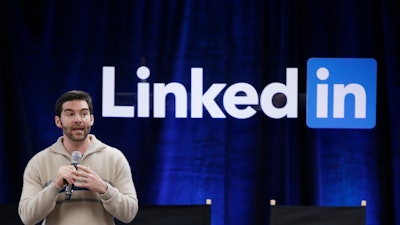 In this file photo, LinkedIn CEO Jeff Weiner speaks during the company's second annual 'Bring In Your Parents Day,' at LinkedIn headquarters. Microsoft is buying the professional networking service site for about $26.2 billion.
