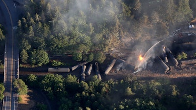 In this June 3, 2016, file photo, an oil train burns near the town of Mosier, OR after derailing. Summary