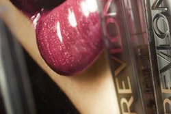 In this May 8, 2007, file photo, Revlon lipstick is displayed in a New York pharmacy. Revlon Inc. announced Thursday, June 16, 2016, that the company is buying Elizabeth Arden Inc. for about $419.3 million in cash, a deal that unites two well-known names in the world of beauty and cosmetics.