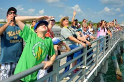 The Kopp family from Pennsylvania, foreground, watch the launch of the SpaceX Falcon 9 rocket from Cape Canaveral Air Force Station from the fishing pier Wednesday, June 15, 2016, in Port Canaveral, Fla. A leftover SpaceX rocket booster crashed Wednesday while trying to land on an ocean barge after the Falcon 9 rocket successfully launched two satellites from Cape Canaveral, Florida.