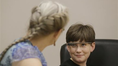 Julian Brown, right, talks with his mother Kristen during a meeting with Jena Daniels, a clinical research coordinator at The Wall Lab in Stanford, Calif., Wednesday, June 22, 2016. Like many autistic children, Brown, 10, has trouble reading emotions in people's faces, one of the biggest challenges for people with the neurological disorder. Now Brown is getting help from 'autism glass' - an experimental device that records and analyzes faces in real time and alerts him to the emotions they're expressing.