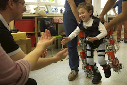 Five-year-old Álvaro, who suffers from spinal muscular atrophy, walks towards his parents during an exoskeleton test.