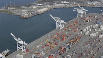 In this Feb. 5, 2016, file photo, the former Oakland Army Base pier at left and the Port of Oakland at lower right in Oakland, Calif. The promise of good, blue-collar jobs in a depressed area is running headlong into environmental sensitivities as officials in Northern California consider a plan to build a marine terminal that would serve as a gateway for Utah-mined coal heading to Asia. The terminal is in West Oakland, a historically black neighborhood that's among the poorest and most polluted in the region.