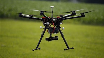 A hexacopter drone is flown during a drone demonstration at a farm and winery on potential use for board members of the National Corn Growers, Thursday, June 11, 2015 in Cordova, Md. Routine commercial use of small drones got a green light from the Obama administration June 21, 2016, after years of struggling to write regulations that would both protect public safety and unleash the economic potential and societal benefits of the new technology.