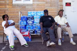 Stephanie Smith, left, Jimmie Thompson, center, and Otis Ross, right, share a laugh in-between residents coming to get water at Prince of Peace Baptist Church Wednesday, June 22, 2016 in northwest Flint. Every Monday, Wednesday and Friday the church gives out water for free from 10 a.m. to 2 p.m. 'My brother lives in Atlanta. I try to tell him he doesn't realize how bad the water crisis is here,' Ross said. 'You can't imagine it until you get here.'