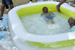 Cassidy Baker, 5, of Flint, reclines in an inflatable pool filled with bottled water on Monday, June 27, 2016, in front of City Hall in Flint, Mich. It took approximately 80 cases of water to fill the pool, said Lisia Williams, Flint resident and event organizer.