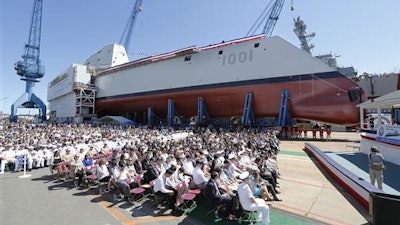 A crowd watches the christening ceremony for the Zumwalt-class guided missile destroyer Michael Monsoor (DDG 1001) Saturday, June 18, 2016 at Bath Iron Works in Bath, Maine.