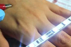 Highly conductive ultrathin film on skin between clips.