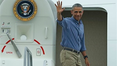 President Barack Obama waves prior to departing on Air Force One from St. Lucie County International Airport in Fort Pierce, Fla. on Sunday, June 5, 2016.