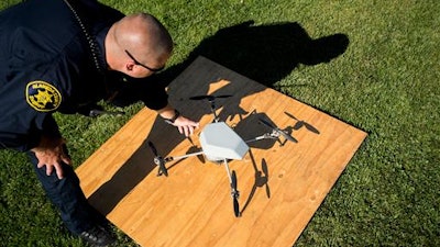In an Aug. 14, 2015 file photo, Alameda County Sheriff's Deputy Dave Durbin prepares to fly a drone during a demonstration of a search and rescue operation, in Dublin, Calif.