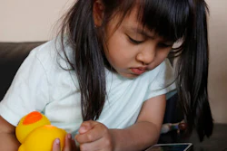 In this May 23, 2016, photo, Kano Matusmoto, 5, plays with Edwin the Duck, a digital duck toy, in the living room of her home in Tokyo. Edwin the Duck, billed as the world’s first “smart duck,” connects by Bluetooth with a smartphone or tablet device such as an iPad to play animation stories and songs. It also works as a regular speaker to deliver music of your choice in bed or in the bathtub.