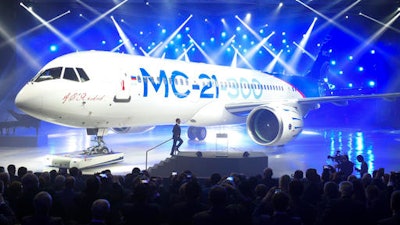 Russian Prime Minister Dmitry Medvedev walks to speak at the unveiling ceremony of a new passenger jet MC-21-300 at a plane at 'Irkut' corporation assembling plant in Irkutsk, Russia, Wednesday, June 8, 2016. Russia unveiled new MC-21-300 airliner ahead of flight tests for the new passenger jet.