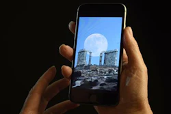 This June 21, 2016 photo shows a smartphone held for a photograph in New York. In a letter published Wednesday, June 22, 2016 in the New England Journal of Medicine, doctors detailed separate cases of two women who experienced 'transient smartphone blindness' for months. Doctors discovered it was caused when they looked at their device with one eye while in bed in the dark _ and their other eye covered by a pillow.