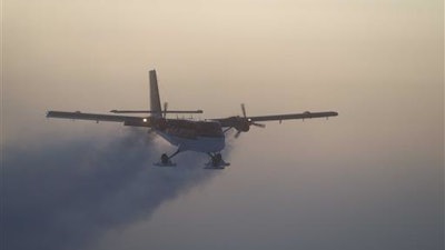 In this 2003 photo, provided by the National Science Foundation, a Twin Otter flies out of the South Pole on a previous medical flight. A daring South Pole medical rescue is underway. An airplane left a British base in Antarctica Tuesday, June 21, 2016, for the 1,500-mile trip to evacuate a sick person from the U.S. station. Athena Dinar, spokeswoman for the British Antarctic Survey, said one of two twin otter planes began the trip Tuesday, while the other is still at the Rothera station on the Antarctic Peninsula just in case.