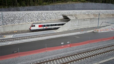 In this Oct. 8, 2015 file photo a test train drives close to the northern gate near Erstfeld, Switzerland. The celebrations of the opening of the Gotthard Base Tunnel will start on June 1, 2016. With a length of 57 km (35 miles) crossing the Alps, the Gotthard Base tunnel is the world's longest train tunnel.