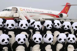 In this photo released by China's Xinhua News Agency, people in panda costumes pose in front of a Chengdu Airlines ARJ21-700 plane before its first commercial flight at Chengdu Shuangliu International Airport in Chengdu in southwestern China's Sichuan Province Tuesday, June 28, 2016. The ARJ21-700, made by the Commercial Aircraft Corporation of China Ltd. (COMAC), is China's first homegrown regional airliner and can seat 78 to 90 passengers depending on its configuration.