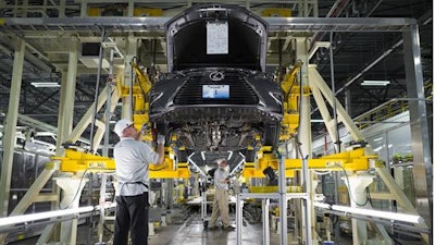 This Oct. 5, 2015, photo provided by Toyota shows workers at a Lexus Plant in Georgetown, Ky. Toyota is marking the 30th anniversary since work started on the Georgetown plant and has a ceremony scheduled Wednesday, June 8, 2016, to celebrate.