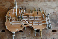 A part of a violin is shown at violin making school in Milan, Italy, Wednesday, May 4, 2016. Acoustics aren’t all that count when making a violin. Aesthetics are also a key element. And that’s why the craft of making stringed instruments is thriving in Italy, a country known for its love of beauty and long history of violinmaking.
