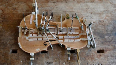 A part of a violin is shown at violin making school in Milan, Italy, Wednesday, May 4, 2016. Acoustics aren’t all that count when making a violin. Aesthetics are also a key element. And that’s why the craft of making stringed instruments is thriving in Italy, a country known for its love of beauty and long history of violinmaking.